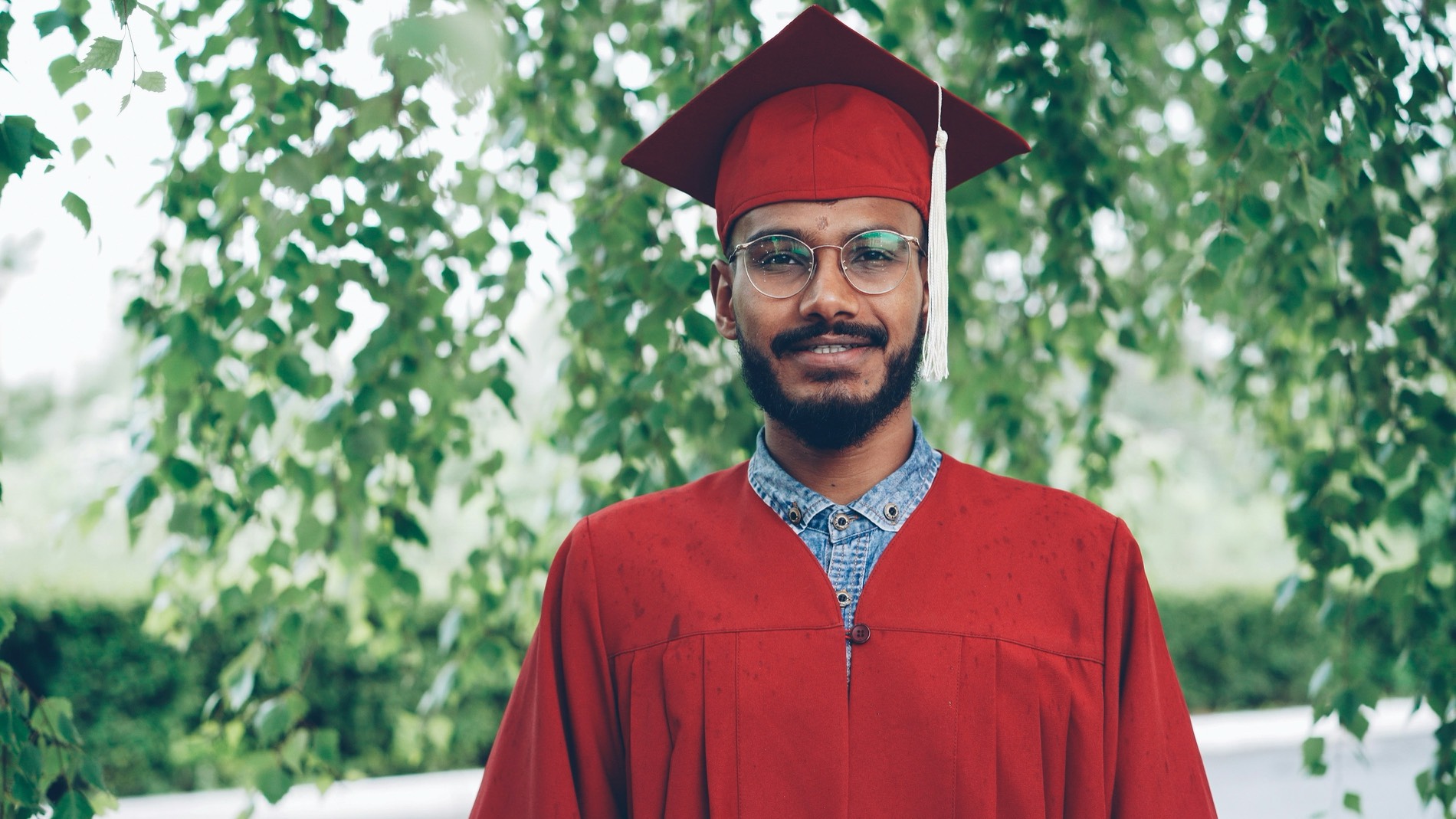 Smiling graduate in cap and gown