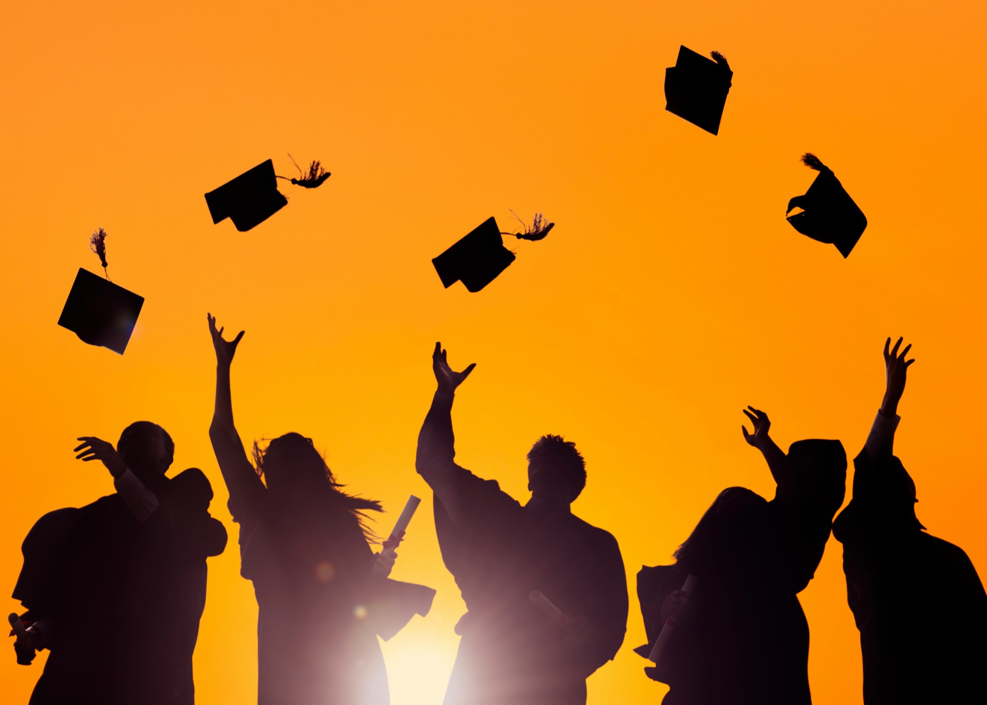 Graduates throwing their caps in the air