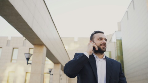 Professional in a suit taking a call outside an office
